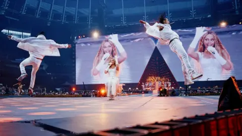 Parkwood Entertainment Beyoncé performing on stage in all-white.