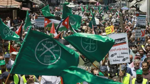 Green flags of the Muslim Brotherhood seen flying during a protest in Bahrain in 2019. 