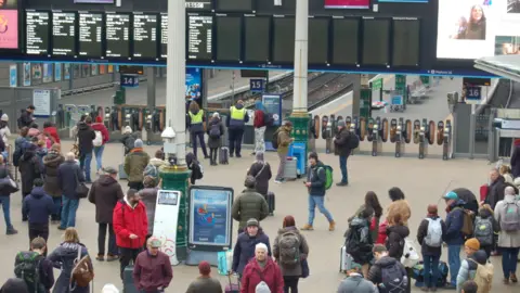 PA Media Passengers at Waverley Station in Edinburgh