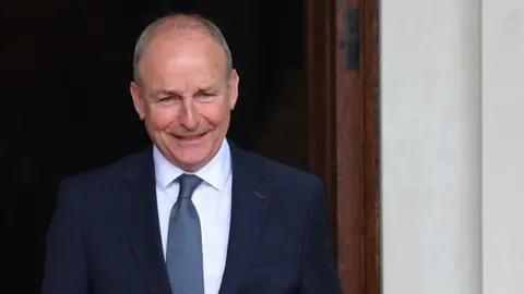 PA Media Taoiseach Micheál Martin. Grey hair, blue suit.