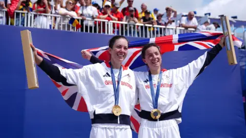 PA Media Great Britain's Emily Craig (left) and Imogen Grant (right) celebrate with their gold medals during the ceremony for the Rowing Lightweight Women's Double Sculls Finals at the Vaires-sur-Marne Nautical Stadium on the seventh day of the 2024 Paris Olympic Games in France.