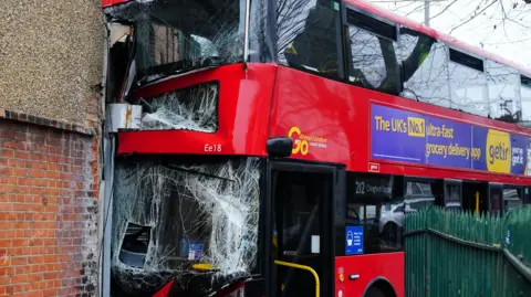 Double decker bus crashed into wall with smashed windscreen