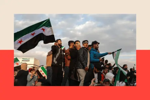 AFP via Getty Images People wave flags during celebrations for the ousting of president Bashar al-Assad 