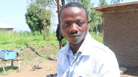 BBC 'Bigboy' stands outside near a motorbike 