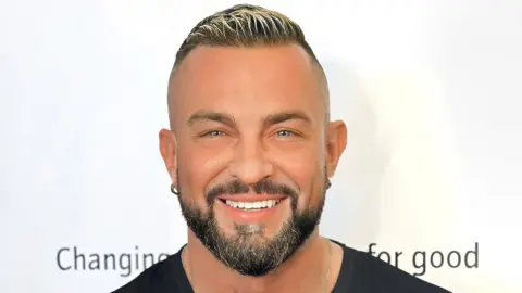 Robin Windsor in a black T-shirt. He is looking directly at the camera