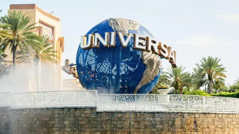 A large blue globe on display outside a Universal theme park in the USA.