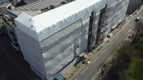 An ariel view of Evolution Cove in Plymouth covered in white sheeting.