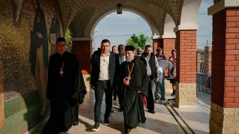 Getty Images George Simion, presidential candidate and leader of the Alliance for the Union of Romanians (AUR) visits the Pantocrator Monastery in Draganesti-Vlasca, Romania 