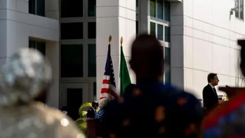 Some Nigerians watch as former US Secretary of State Antony Blinken speaks at the US Embassy in Abuja in 2021