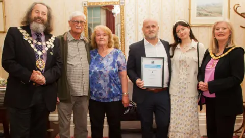 Far left - Mayor of Bournemouth, George Farquhar nominated Darren Wiles. Far right - award presented by Chairman of BCP, Cllr Lesley Dedman 