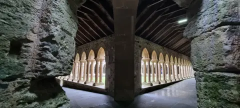 Rob Young Panoramic image of arches in the Abbey, framed by old stone walls