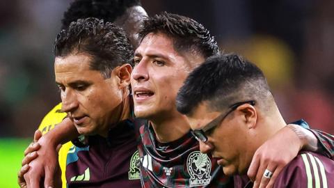 Edson Alvarez (centre) leaves the pitch injured during Mexico's win against Jamaica at the Copa America