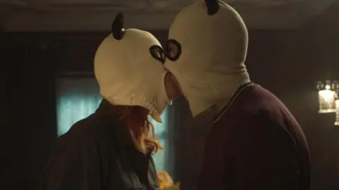 University of Lincoln Couple in horned balaclavas snogging