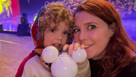 Supplied Woman and boy with curly hair.