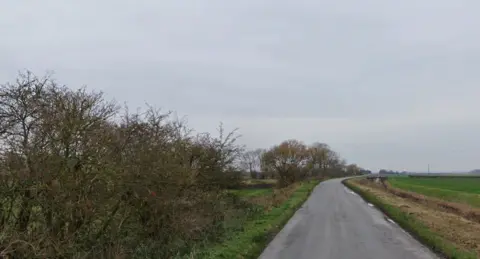 Fen Bank near Friskney. It is a narrow country lane with a dyke running along the right hand side.