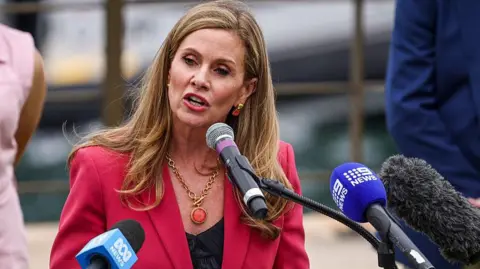AFP via Getty Images Julie Inman Grant speaks during an official function to mark the start of Australia's social media reform at Kirrilbilli House in Sydney on December 10, 2025