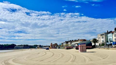 WEDNESDAY - An empty sandy beach in Weymouth on a sunny day