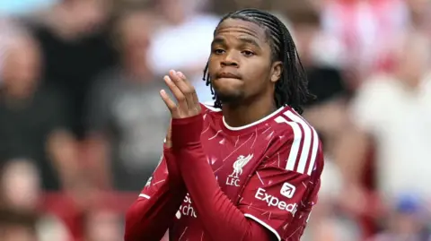 Liverpool's 17-year-old winger Rio Ngumoha clapping