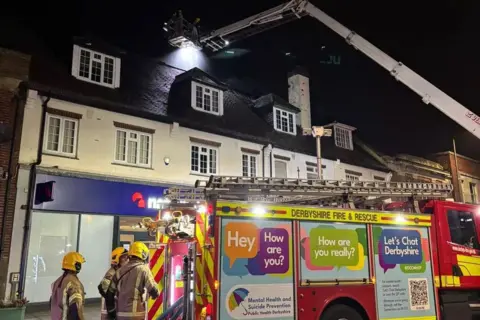Enchanted Rose Fire crews fighting a fire in the second floor of a commercial premises at night