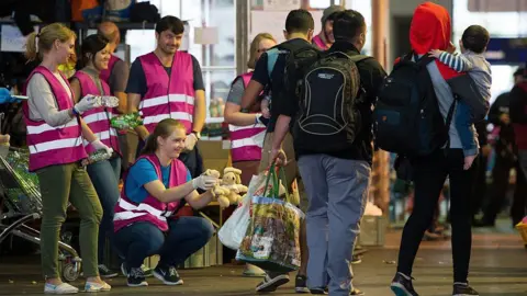 Germans welcome refugees at a train station in 2015.