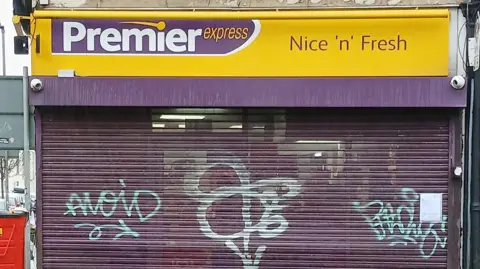 Portsmouth City Council Front of a Premier convenience shop with its shutters down