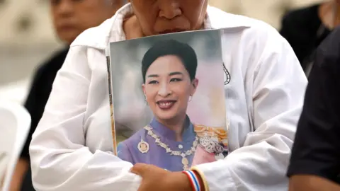 A Thai mourner holds a photograph of Thai Princess Bajrakitiyabha after the announcement of her death.