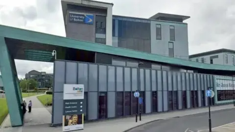The green and grey exterior of the Sir Jason Kenny Centre at what was then called the University of Bolton.