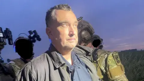 Suspected gunman Vance Luther Boelter apprehended by armed officersr