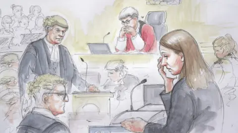 Helen Tipper A sketch of Lucy Letby appearing in court at Manchester Crown Court surrounded by legal counsel