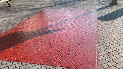 Square of pavement painted red