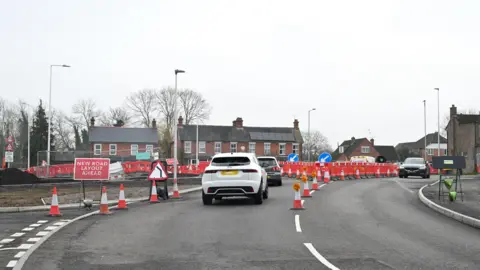 A picture of cars driving around the area that is being affected by the South Wokingham Distributor Road project.