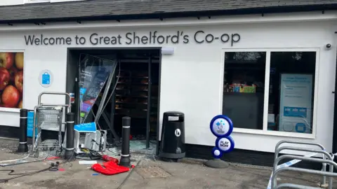 Harriet Heywood/BBC Great Shelford's Co-op branch with a broken down door