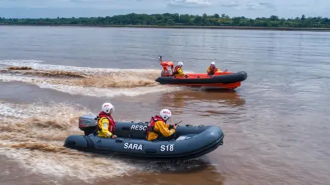 Two lifeboats with SARA crews on the River Severn.