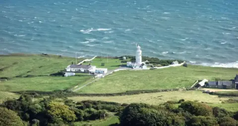 St Catherine's Point, Isle of Wight - onshore lighthouse standing on downswith sea stretching behind.