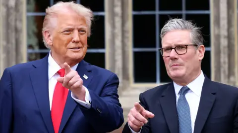 US President Donald Trump and Prime Minister Sir Keir Starmer point at cameras at Chequers during the president's state visit to the UK in September.