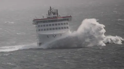 IOMSPC The Manxman, a large white ferry, with a large wave crashing at the front of it.
