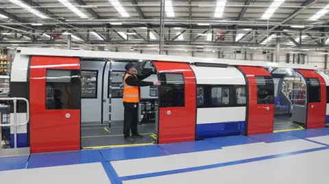 PA Media Siemens engineer standing on a new train during a press call at a Siemens factory in Goole 