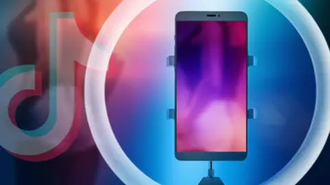 BBC Designed image showing a ring light, a mobile phone showing a blurred image of a young woman dancing, and a treated image of part of the TikTok logo