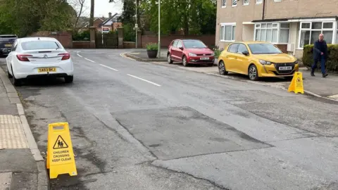LDRS Two mobile Children Crossing - Keep Clear warning signs near kerbs at Middleton Lane.
