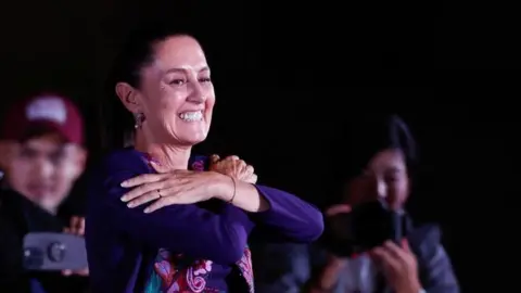 Reuters A smiling Claudia Sheinbaum gestures to supporters after being declared the winner of the presidential election in Mexico City, Mexico June 3, 2024