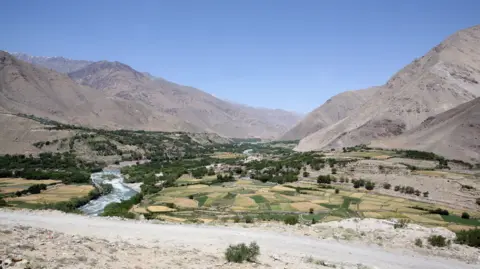 A file picture of the Sangin valley in Afghanistan with arid mountains in the background and a fertile valley in the foreground