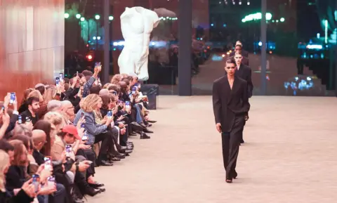 Stephane Cardinale/Corbis via Getty Images Models walk the runway during the Saint Laurent Womenswear Fall/Winter 2026-2027 show as part of Paris Fashion Week on March 03, 2026 in Paris, France.