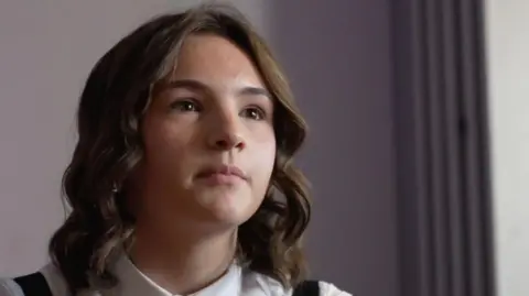 A headshot of a teenage girl