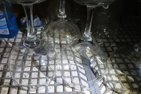 Portsmouth City Council Wine glasses on a dirty surface.