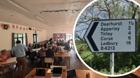Deerhurst and Apperley sign and residents sitting down at the meeting. 