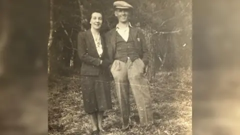 Family handout A man and woman stood on leaves in a black and white photo.