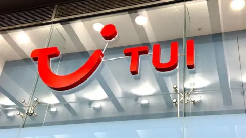 A Tui sign on a glass background