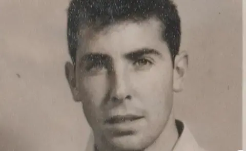 Harry McGuigan An old black and white image of Harry, where he is much younger and has dark hair. 