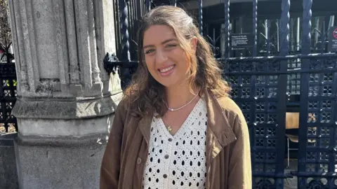 Gwen Kuhlman smiling outside Parliament