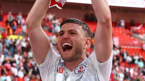 Laurence Maguire celebrates winning promotion on loan with Crawley